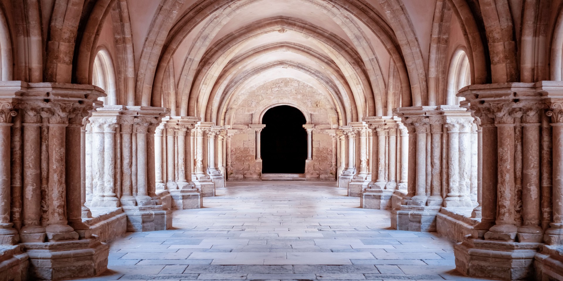 Sunlit gothic corridor cathedral courtyard. Wallpaper